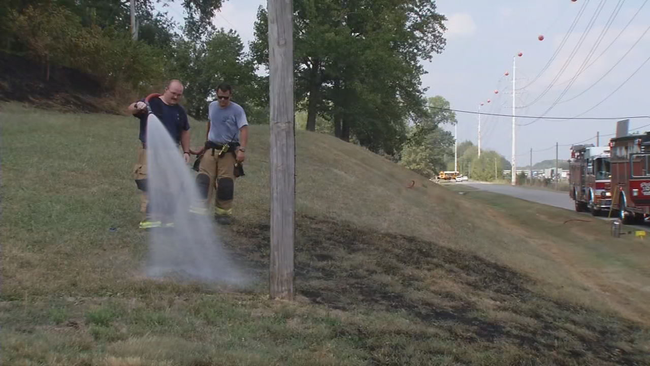 Firefighter Hosing Down Grass